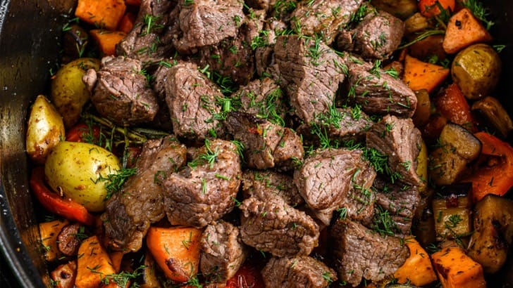 Cubed cooked rump roast in pot with vegetables.