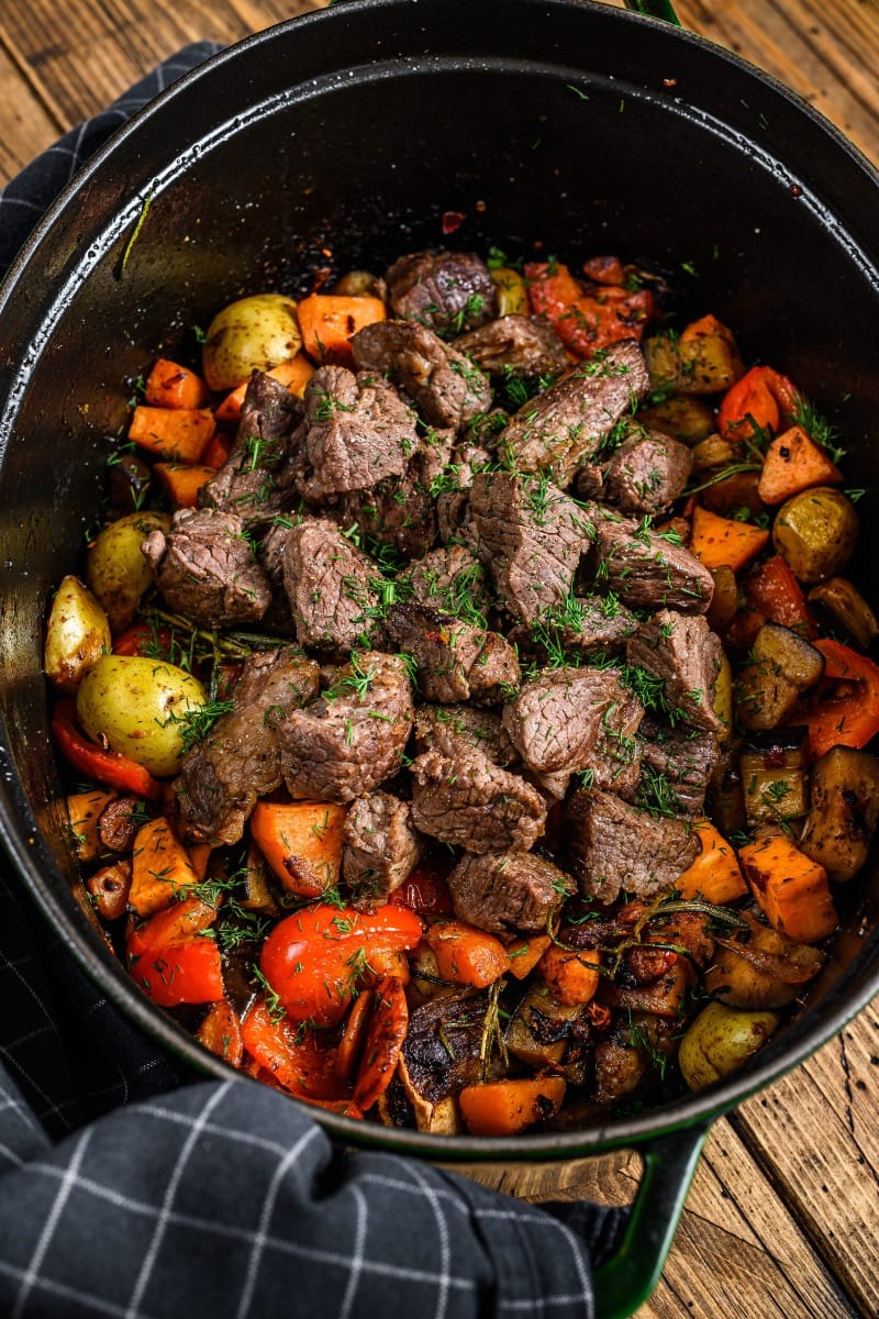 Cubed cooked rump roast in pot with vegetables.