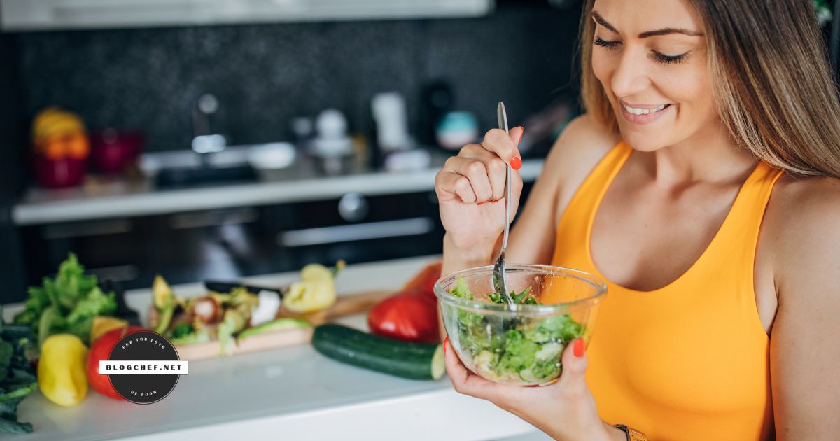 Woman eats salad while smiling.