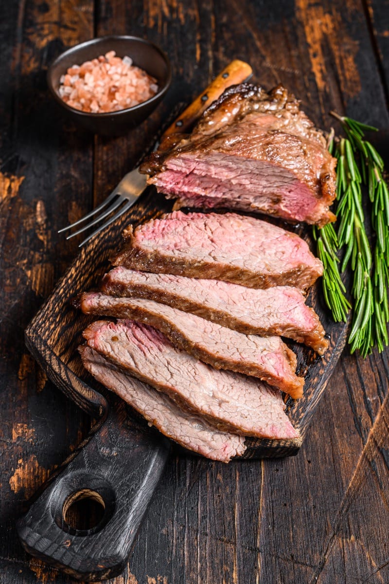 Slices of prepared tri-tip steak on platter.