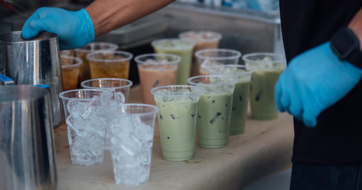 Multiple prepared taro tea drinks on table.