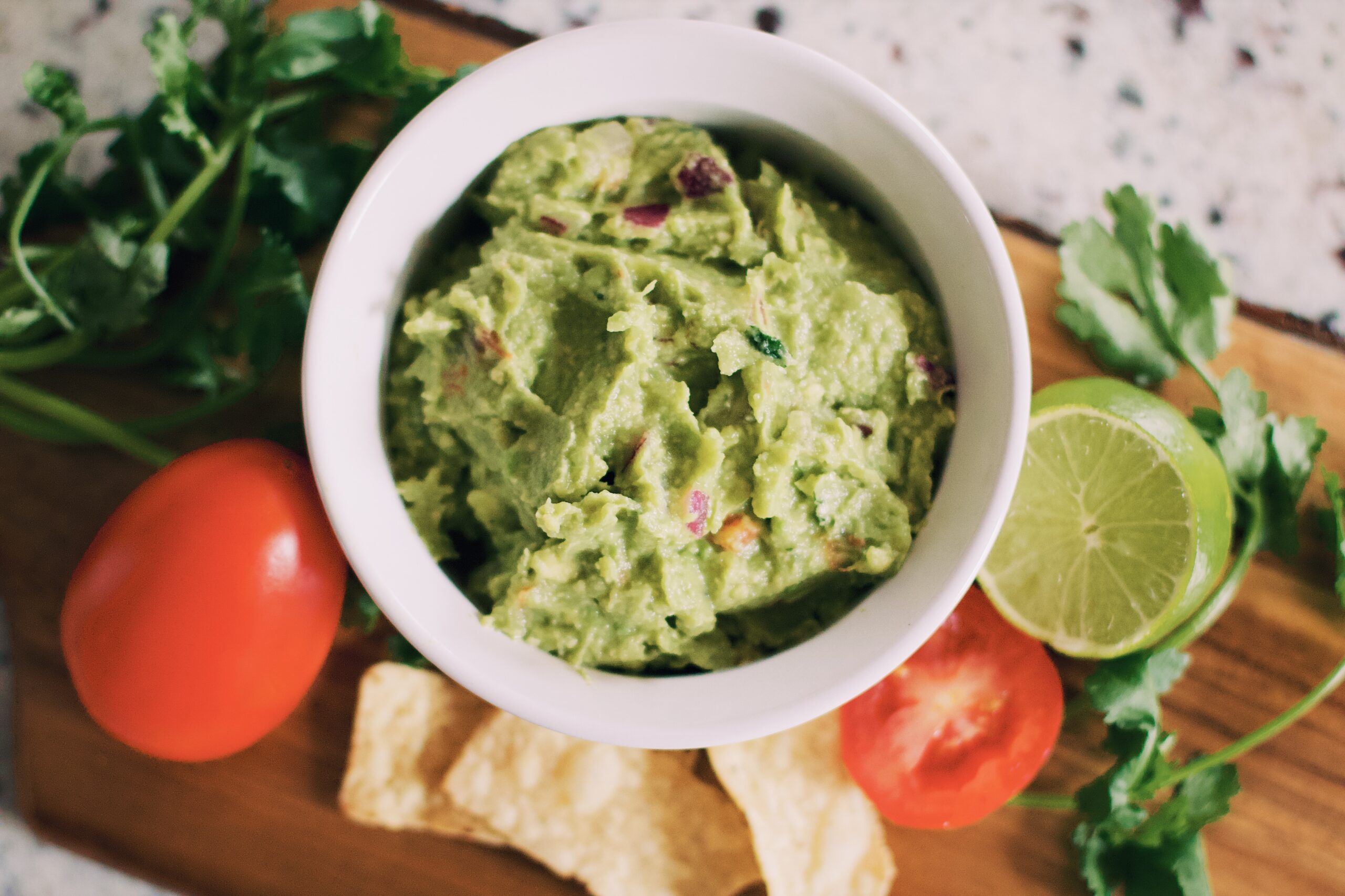 Guacamole with veggies in background