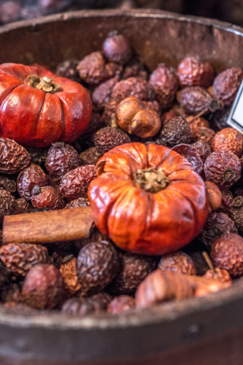 Dried spices with small pumpkins in a container. 