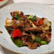 Sizzle steak with bell peppers and onions on plate