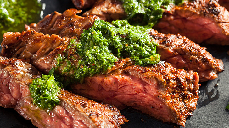 Skirt steak topped with chimichurri.