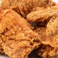 Fried chicken on white plate.