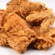 Fried chicken on white plate.