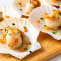 Prepared scallops on cutting board.