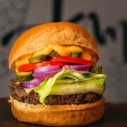 prepared hamburger with cheese, sauce and toppings