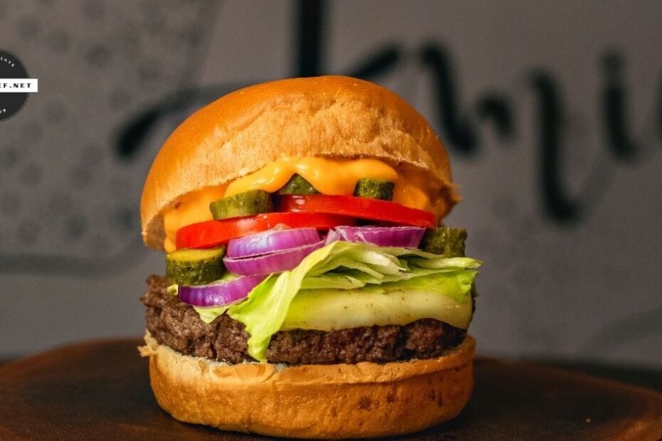prepared hamburger with cheese, sauce and toppings
