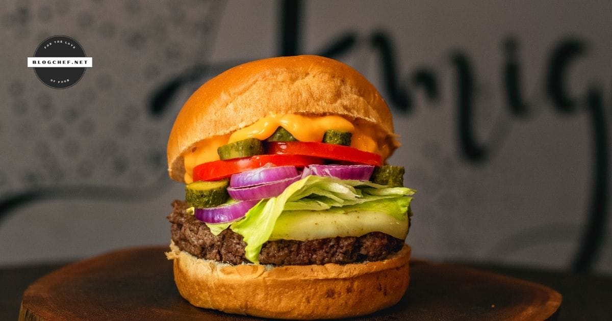 prepared hamburger with cheese, sauce and toppings