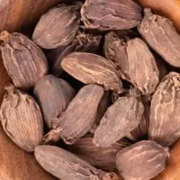 Black cardamom in bowl.