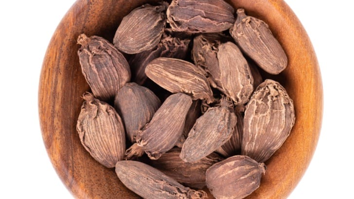 Black cardamom in bowl.