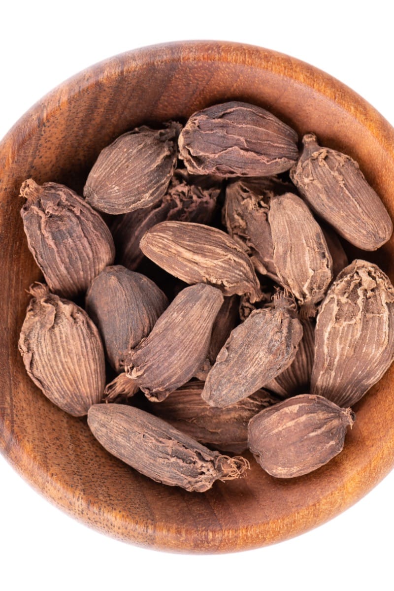 Black cardamom in bowl.