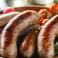 Bratwurst prepared on serving tray.