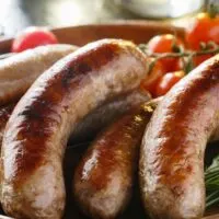 Bratwurst prepared on serving tray.