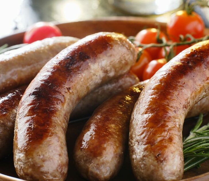Bratwurst prepared on serving tray.