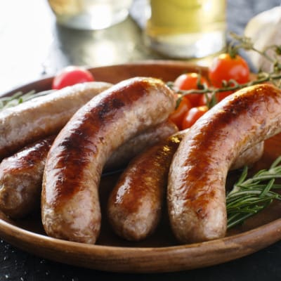 Bratwurst prepared on serving tray.