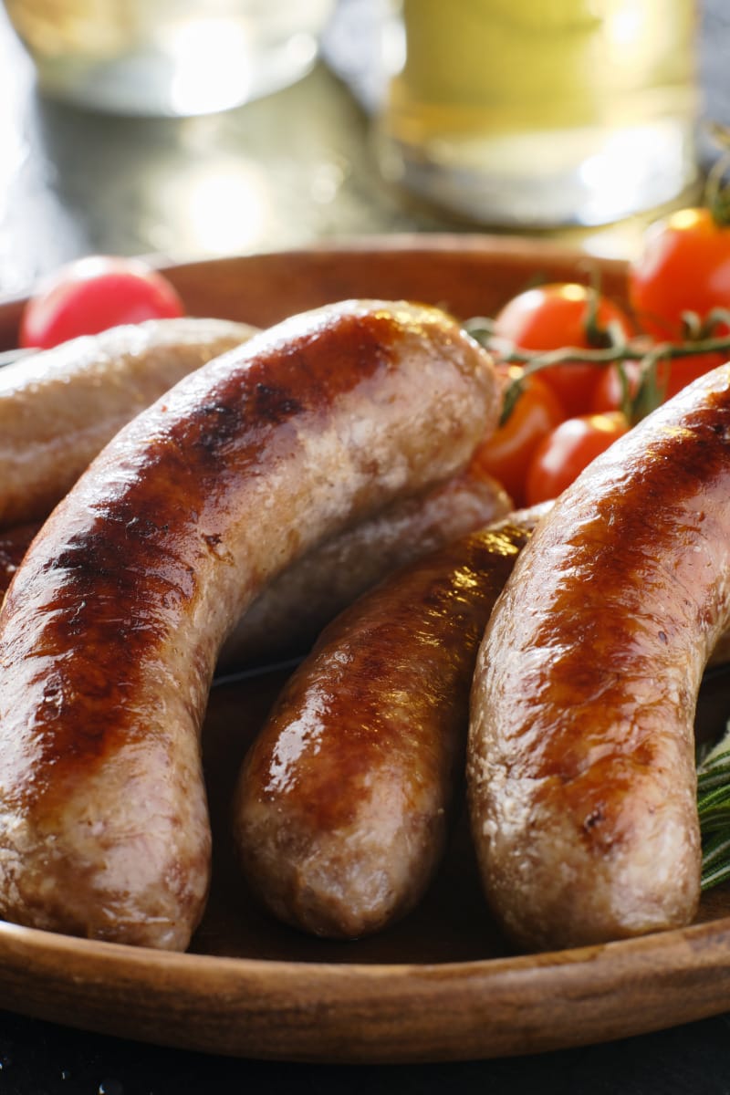 Bratwurst prepared on serving tray.