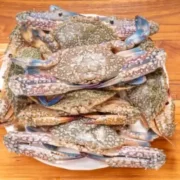 Blue crab on cutting board.