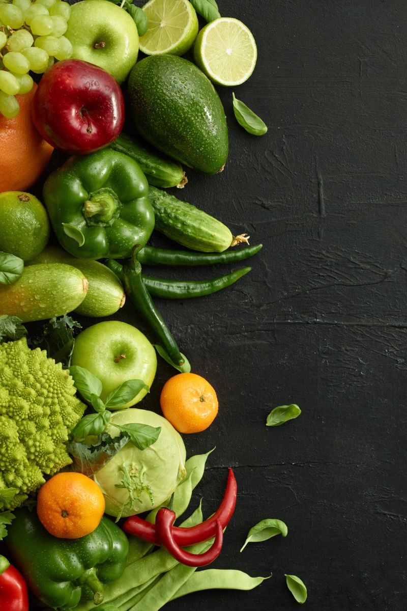 An assortment of raw vegetables on a dark background.