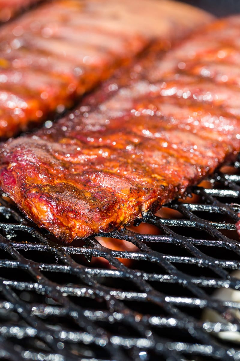 Baby back ribs cooking on gas grill. 