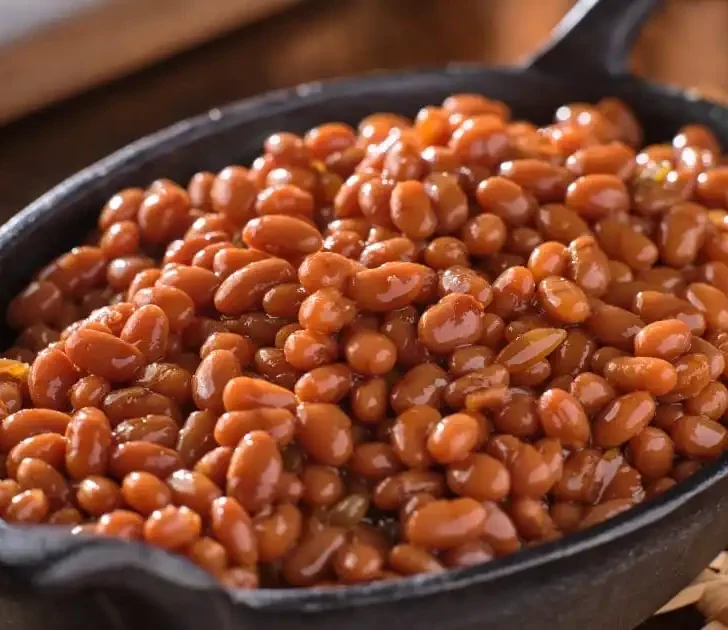 Baked beans in cast-iron skillet.