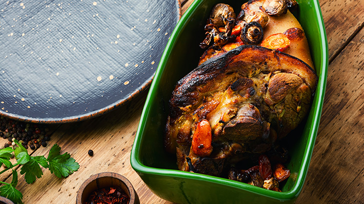 Cooked ham hock in a serving dish to represent how long to cook ham hocks.