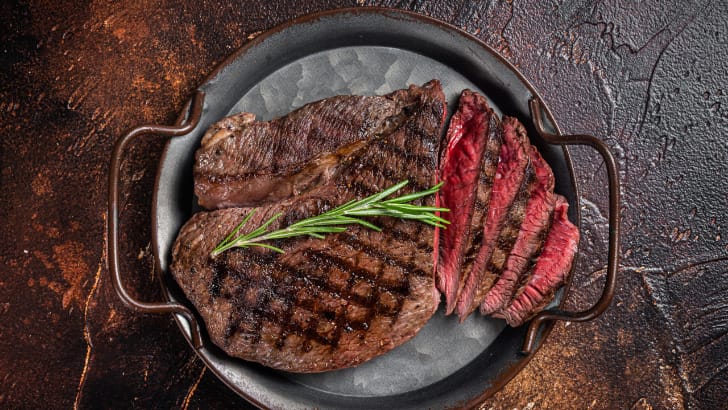 Top view of grilled steak, cooked to medium rare and sliced.