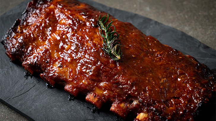 Cooked spare ribs on platter.