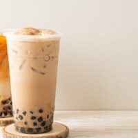 Thai tea boba against brown background.