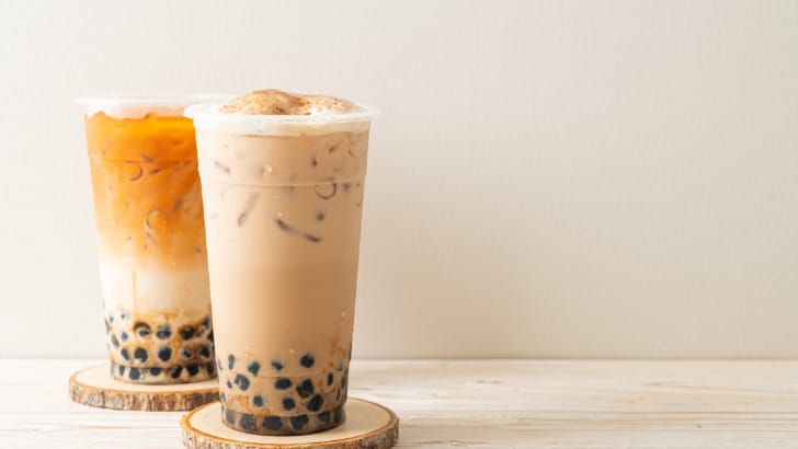 Thai tea boba against brown background.