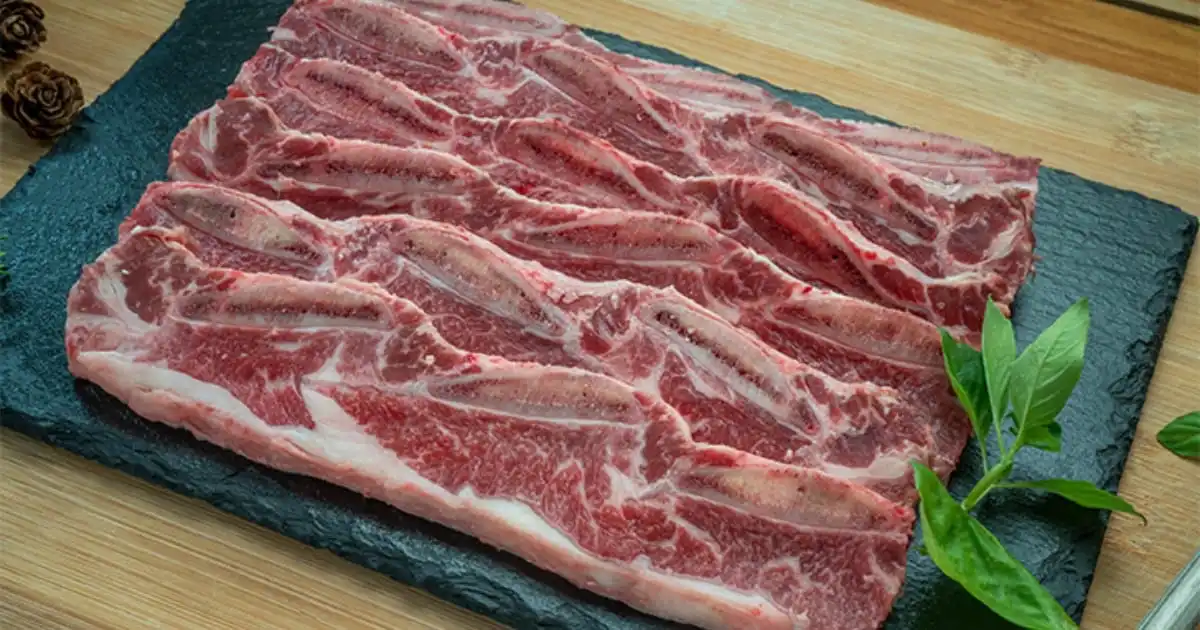 Raw boneless beef ribs on tray.