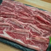 Raw boneless beef ribs on tray.