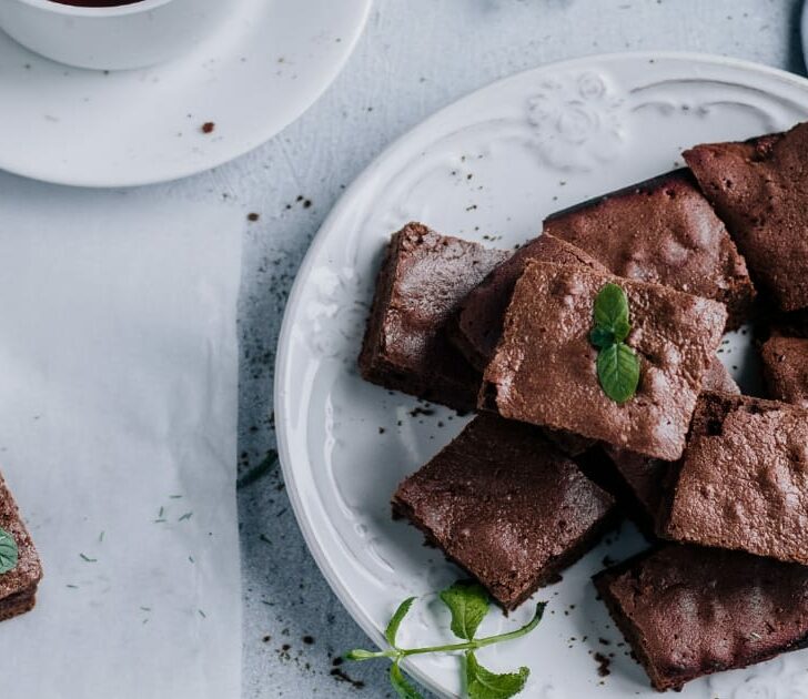 Chocolate brownie squares on serving plate.