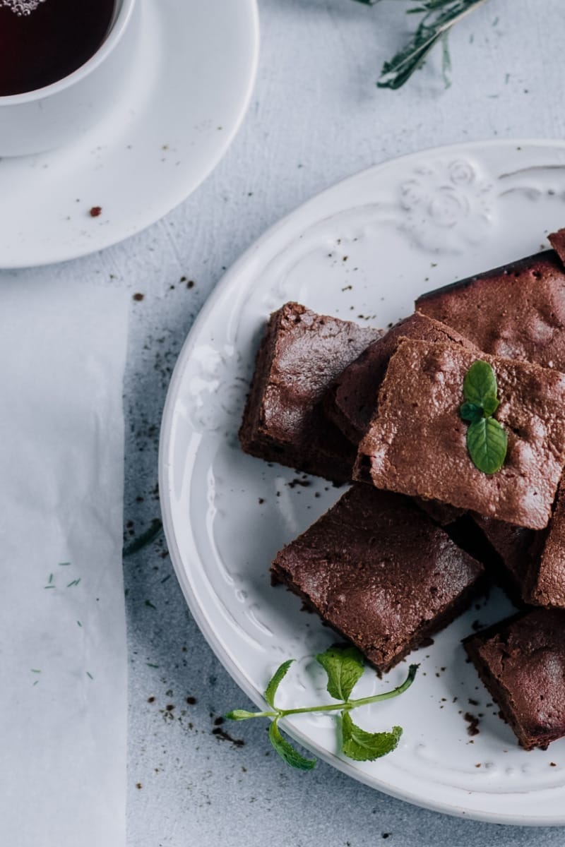 Chocolate brownie squares on serving plate.