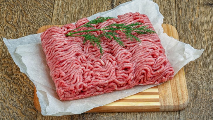 Raw ground turkey with garnish.