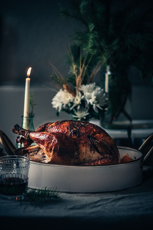 Beautifully roasted whole turkey in a serving dish.