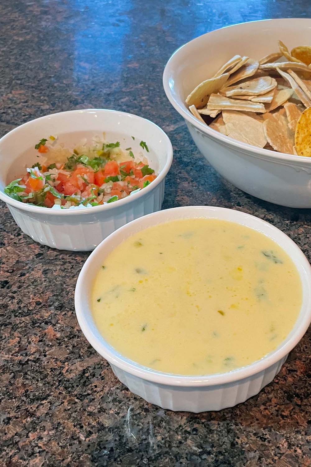 Prepared Applebees queso dip with pico de gallo and tortilla chips.