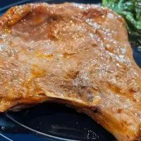 Close up of prepared thin pork chop cooked in the oven.