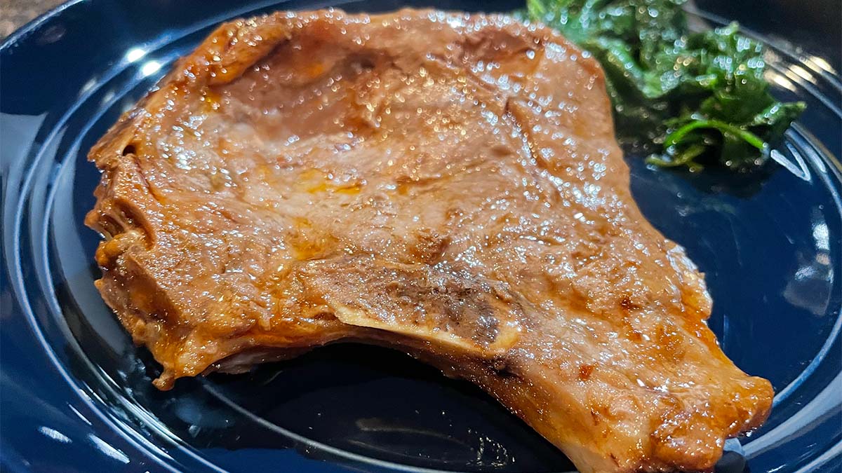 Close up of prepared thin pork chop cooked in the oven.