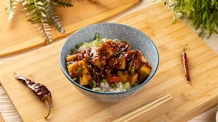 Close-up of tofu stirfry in a bowl.