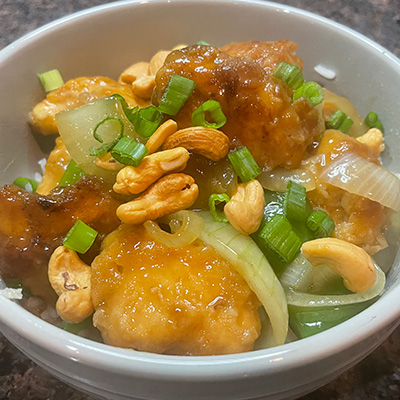 Close-up of prepared cashew chicken in bowl.