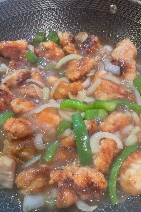 Cashew chicken cooking in sauce.