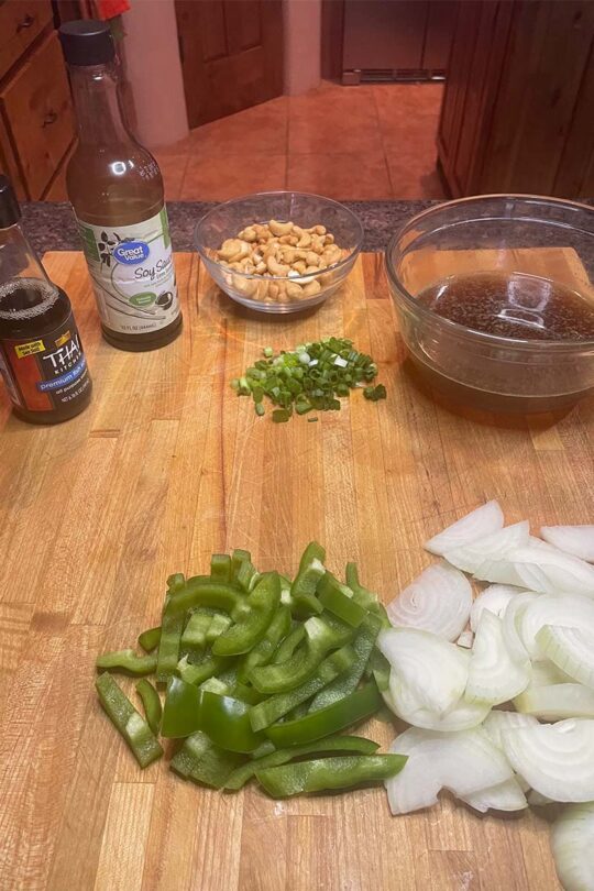 Sliced peppers, onions, and other ingredients needed for cashew chicken. 