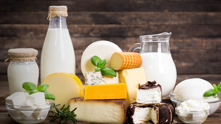 Dairy products arranged against wood background.