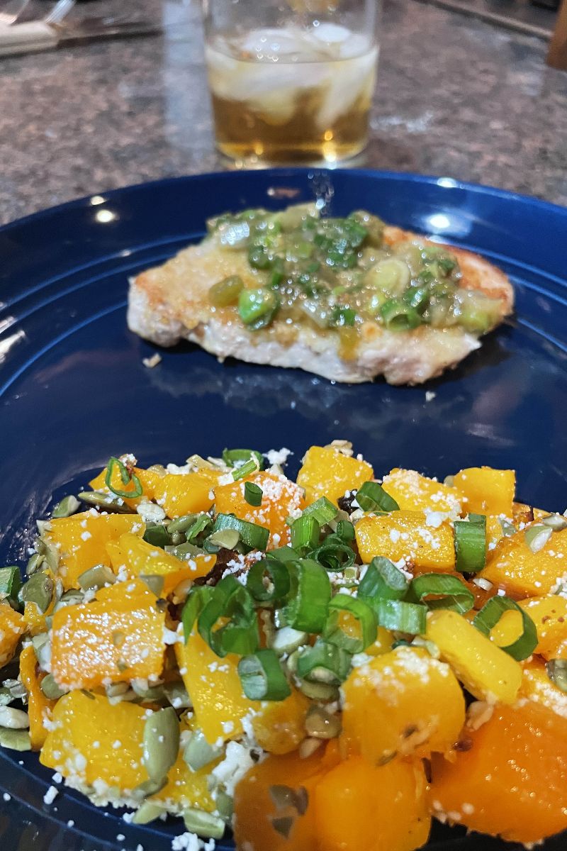Close-up view of Home Chef recipe with butternut squash and pork chop topped with salsa. 