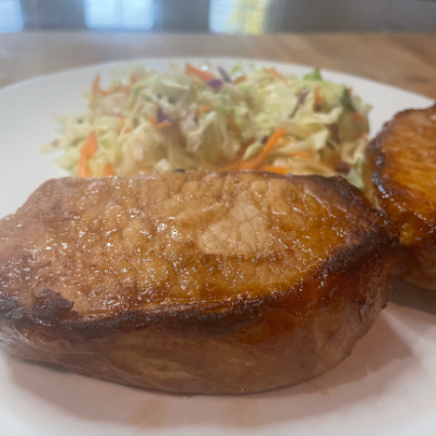 Prepared teriyaki pork loin chops on plate.