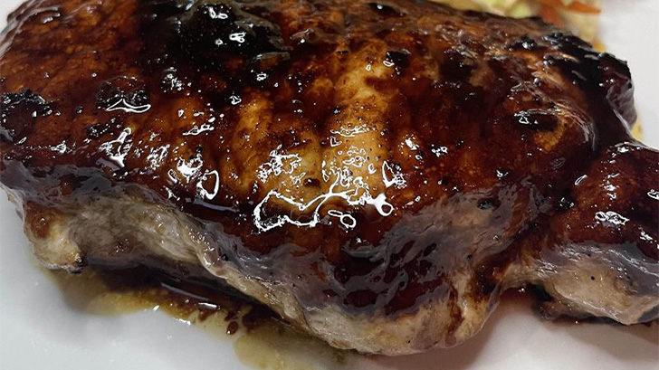 Prepared Korean style pork chops on plate.