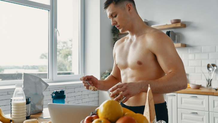 Man measures his food in kitchen.